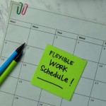 Flexible Work Schedule write on sticky notes isolated on office desk.