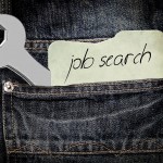 Job search message and spanner peeking out of jeans back pocket