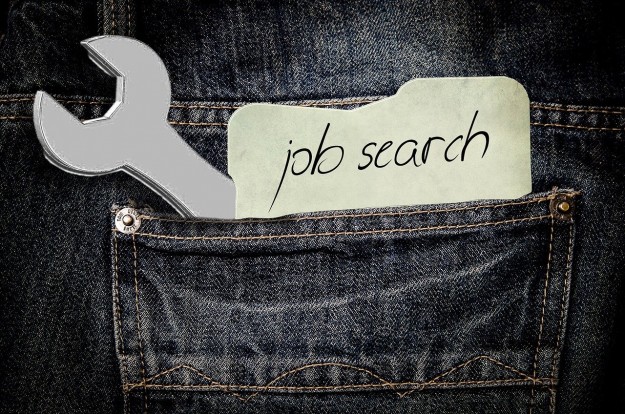 job-search Job search message and spanner peeking out of jeans back pocket